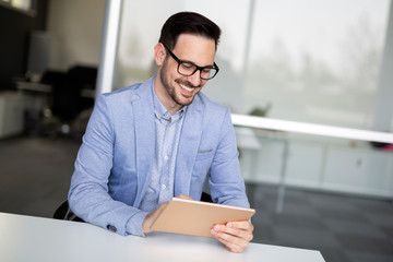 Fototapeta premium Portrait of young businessman, successful entrepreneur working day in office