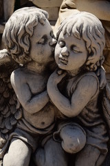Figurines of a little boy and a girl showing love.