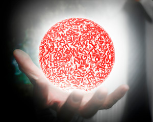 Big data concept. Male hand holding self-illuminated red ball of huge amount 3d letters and numbers with white light.