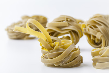 italian spinach tagliatelle nests on white