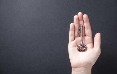 Hand holding old key. Business, success