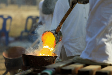 Workers are pouring mater steel production from molten steel.