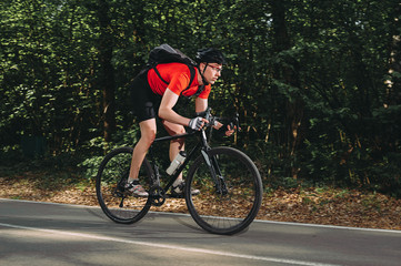 mountain biker rides through the forest road. summer. sport. fitness