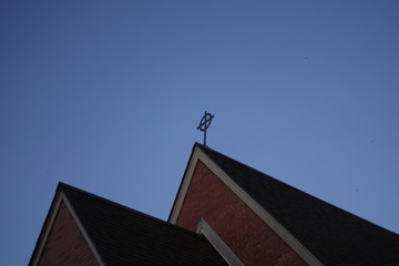 church in the city with a blue sky with no cloud before the dark