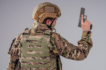 menacing gaze army soldier holding a weapon and a mask