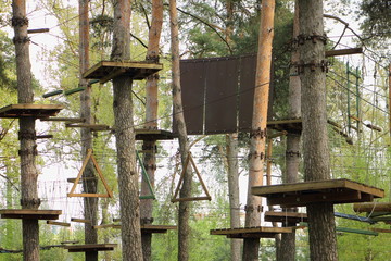 Outdoor rope park in summer day- climbing sports