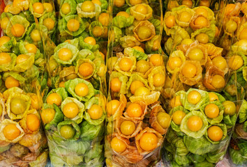 Group of fresh cape gooseberry in plastic bags on stall in a Asia market