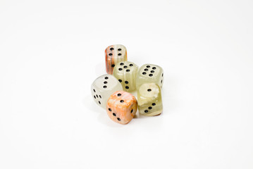 Dices made of natural stone on a white background. Copy space. Gaming.