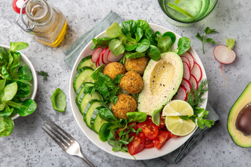  salad with avocado, falafel,cucumber, tomato and redish, healthy vegan lunch bowl