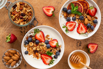 Healthy breakfast concept. Homemade granola, honey, yogurt and fresh berries.