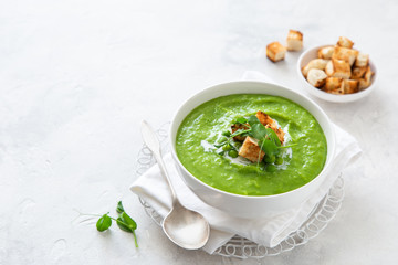 green peas cream soup in white bowl
