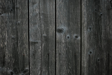 Obraz premium Dark gray shabby boards. Old dark grey fence with hobnail. Antique wooden table. Retro gray wood surface. Old wooden texture background. Dirty parquet.