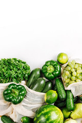 Organic vegetables and fresh green in reusable produce bags. Sustainable lifestyle. Flat lay, top view