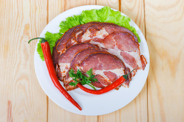 Sliced dried pork neck with greens and chili on dish
