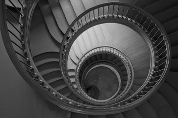 Antique spiral staircase in black and white.