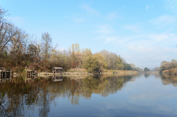 Fototapeta na wymiar Beautiful landscape photo of Holt-Tisza river and riverside in Hungary. Autumn forest morning fog. Best place for fishing.