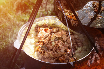Buckwheat porridge cooked in a cauldron at the stake. Spring time