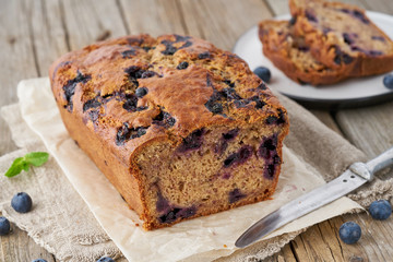 Banana bread on old wooden rustic table, slice of  cake with banana, close up