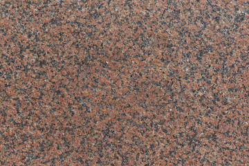 The flat surface of the granite slab is brown in speckled with black spots. Granite consists of...