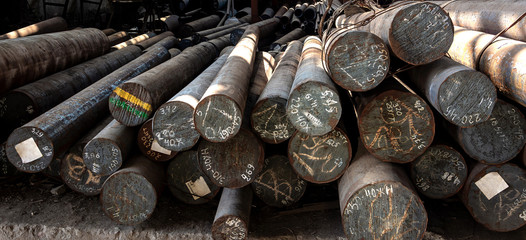 Metal rolling. A round tube are stacked in storage for sale and loading in stock. View from the front, end view, close-up.