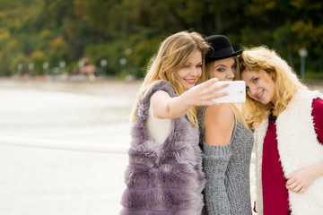Fototapeta premium Three women taking selfie outdoor