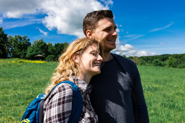 Portrait of young couple enjoying hiking together in nature.