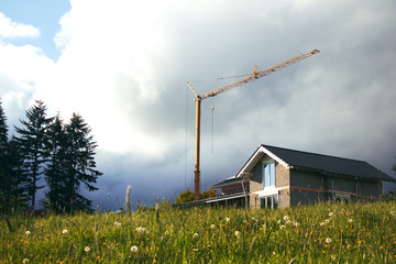 new construction site with crane and dark clouds