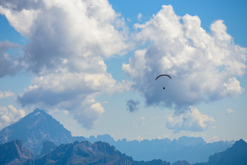 Fototapeta na wymiar parachute action activity ,cloud blue sky at Dolomite Alps, Italy