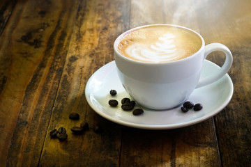 Coffee cup on wooden table at coffee shop. Business time with coffee, Coffee color brown background for product display, free copy space. Industrial food, drink background concept.