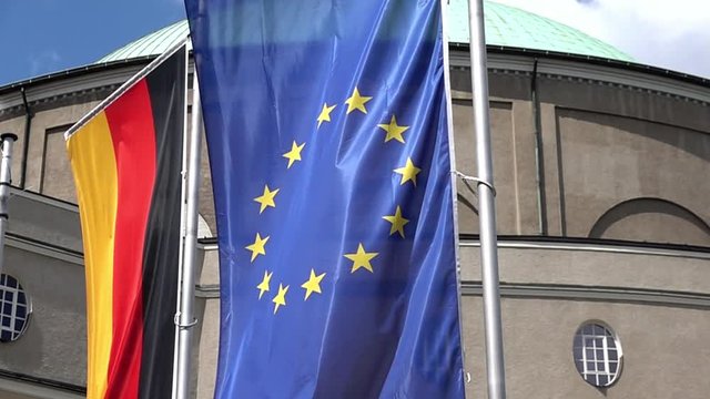 Slow motion of flags of the Federal Republic of Germany and the European Union, EU, gently waving in the wind