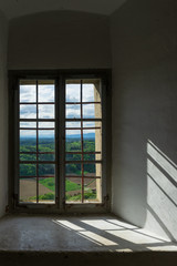 The landscape shines through the old castle's windows