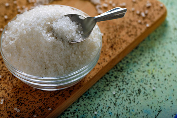 Sugar in glass bowl on wooden background