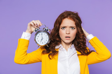 Portrait of a pretty young redheaded woman standing