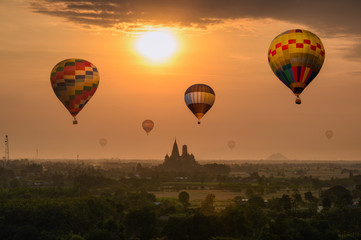 Colorful hot air balloons flying on Wat Tham Sua temple building on hill in sunrise morning
