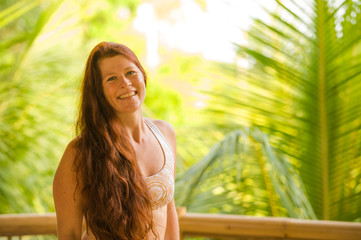 lifestyle fresh and natural portrait of young beautiful and happy red hair woman smiling cheerful and carefree enjoying Summer holidays trip in tropical island
