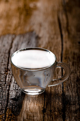 water in cup on wooden background 