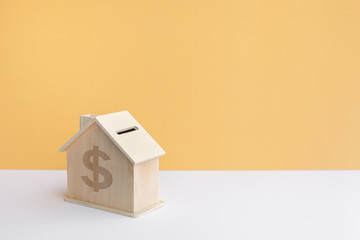 Model of House(home) made by wood in pastel color background.Property and estate or investment concepts