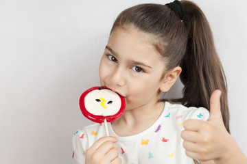 Beautiful cute little child girl eating big lollipop 