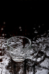 water in cup on wooden background 