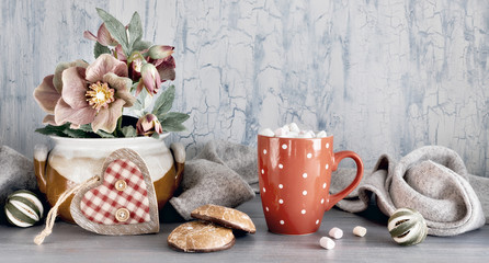 Wintertime, hot chocolate with marshallows, anemone flowers, heart and winter decorations