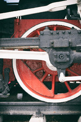 Fototapeta na wymiar Retro steam locomotive wheels and rods. Details of mechanical parts, wheels and equipment of the train.