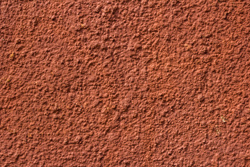 Old crumbling red stucco grunge texture background. Copy space.