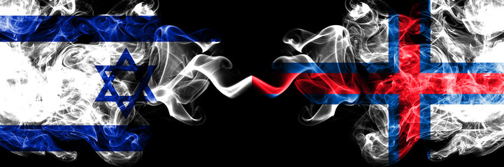 Israel vs Faroe Islands smoky mystic flags placed side by side. Thick colored silky smokes flag of...