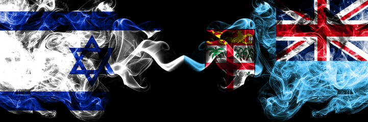 Israel vs Fiji smoky mystic flags placed side by side. Thick colored silky smokes flag of Israel...