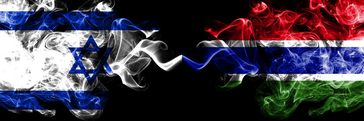 Israel vs Gambia, Gambian smoky mystic flags placed side by side. Thick colored silky smokes flag of Israel and Gambia, Gambian