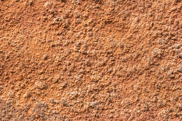 Old crumbling red stucco grunge texture background. Copy space.