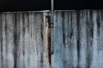 The concrete texture, wall, with cracks and scratches can be used as a background