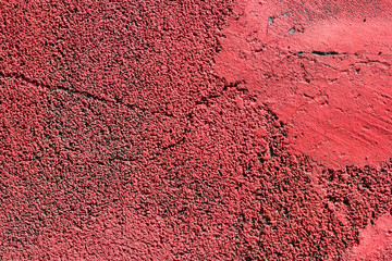 Old crumbling red stucco grunge texture background. Copy space.