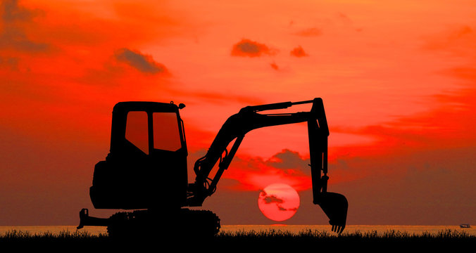 Excavator work on construction site at sunse