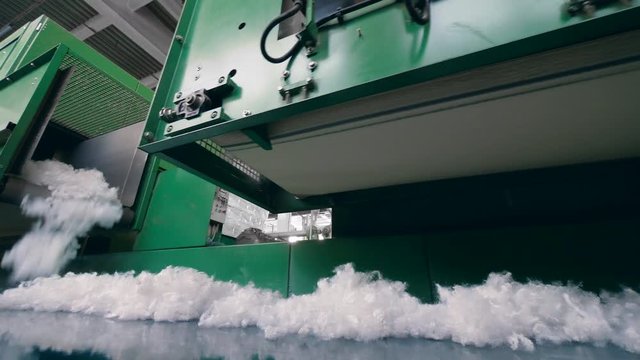 White fiber moving on industrial line at a plant.